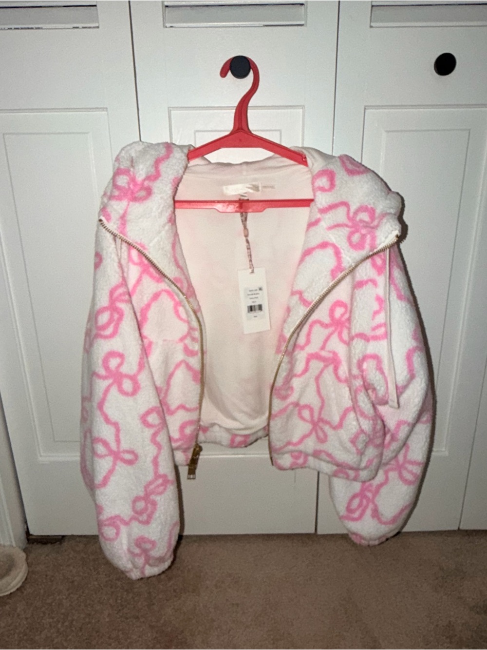 LoveShackFancy pink and white bow bomber jacket